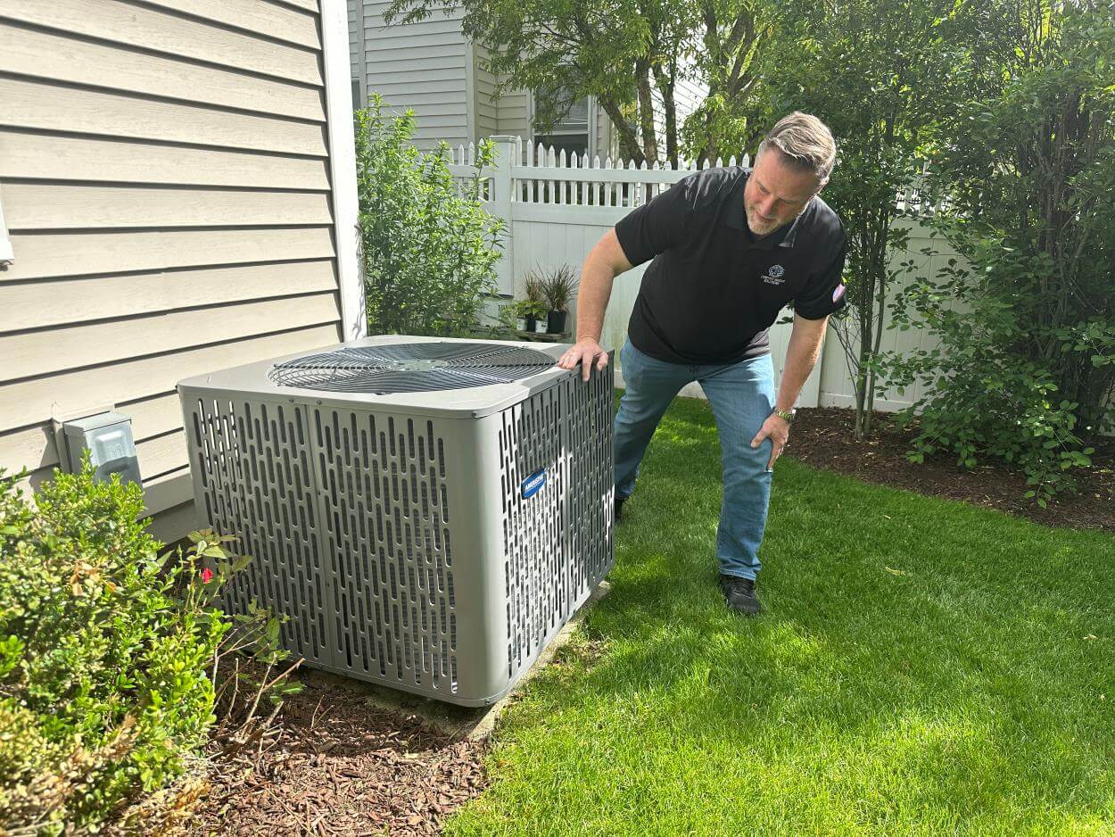 CIS Tech inspecting AC unit